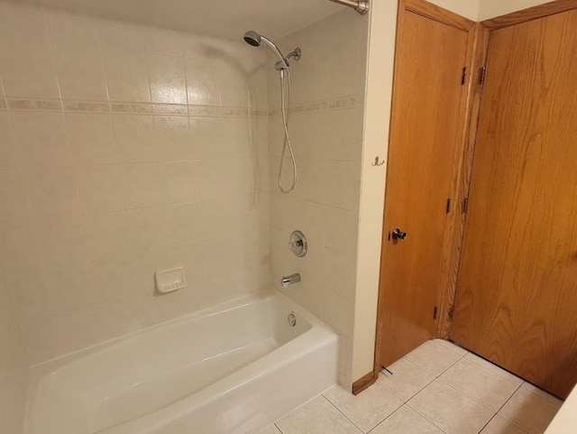 bathroom featuring tile patterned flooring and tiled shower / bath