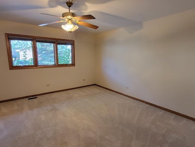 unfurnished room with ceiling fan and light carpet