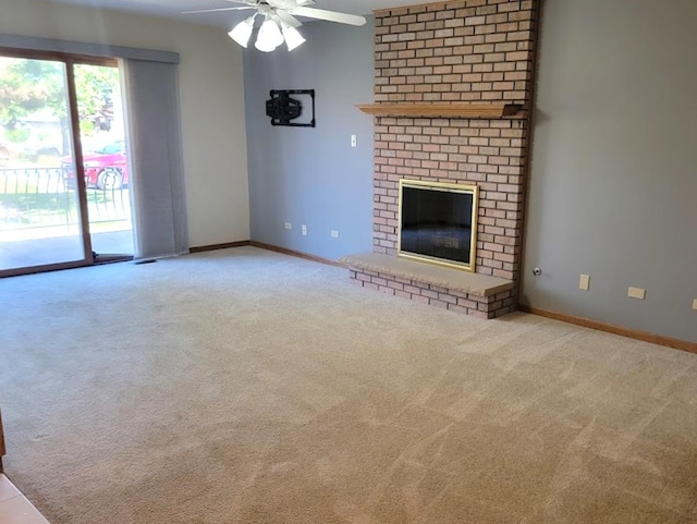 unfurnished living room featuring a brick fireplace, light colored carpet, and ceiling fan