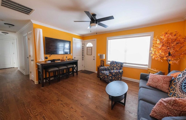 living room featuring dark wood-type flooring, ornamental molding, and ceiling fan