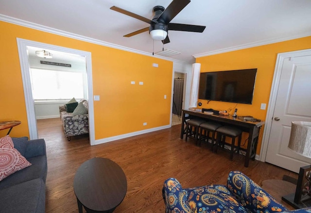 living room featuring dark wood-type flooring, crown molding, and ceiling fan