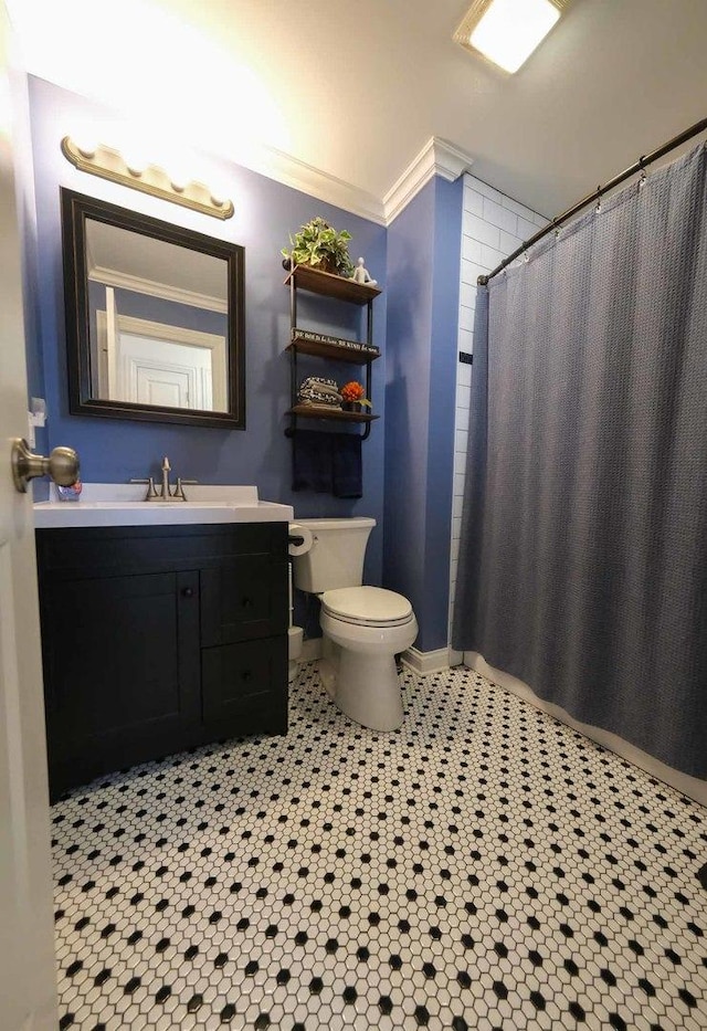 bathroom with curtained shower, tile patterned floors, vanity, toilet, and ornamental molding