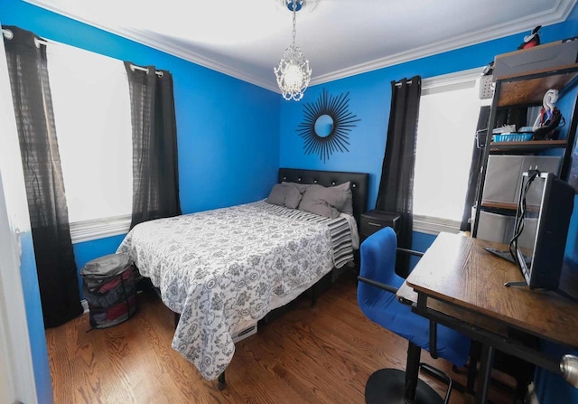 bedroom with dark hardwood / wood-style flooring and ornamental molding