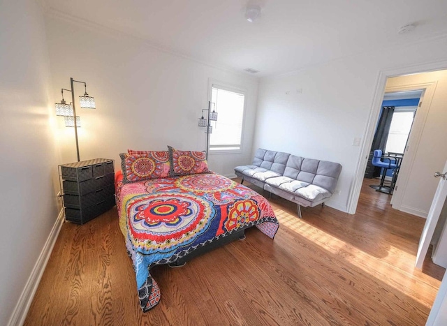 bedroom with hardwood / wood-style flooring