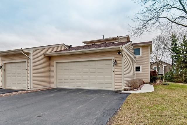 exterior space featuring an attached garage, driveway, and a front lawn