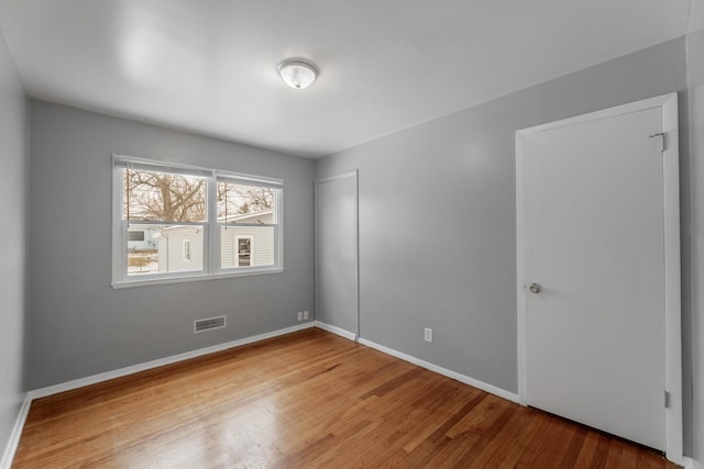 empty room featuring wood-type flooring