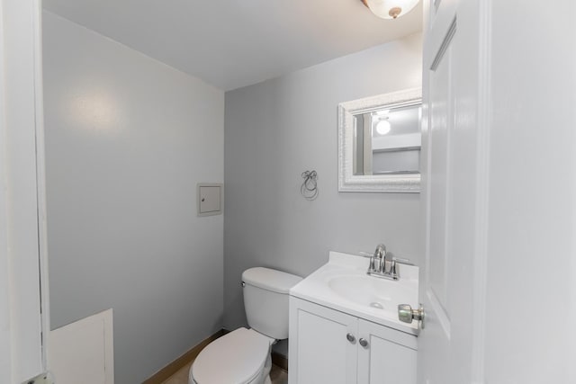 bathroom featuring toilet and vanity