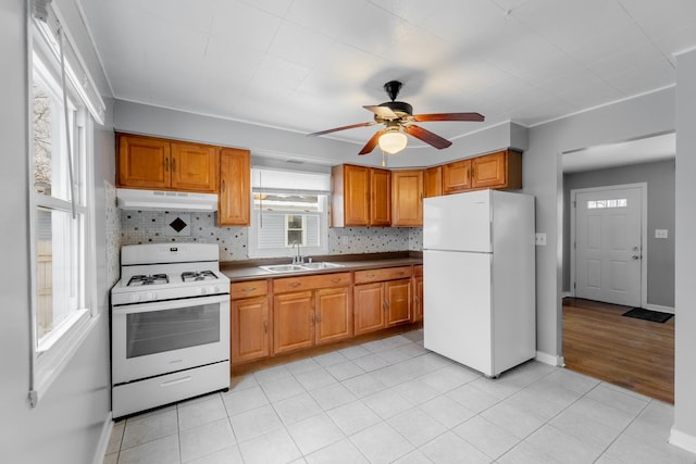 kitchen with ceiling fan, sink, white appliances, and tasteful backsplash