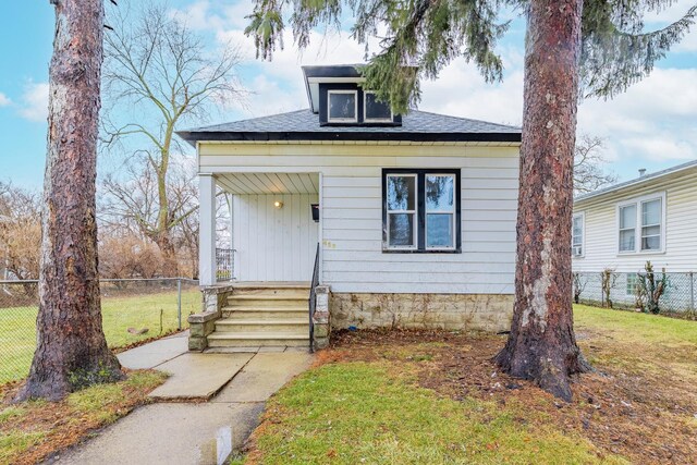 bungalow-style home with a front lawn and a porch