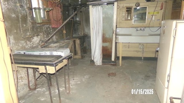 basement featuring sink and water heater