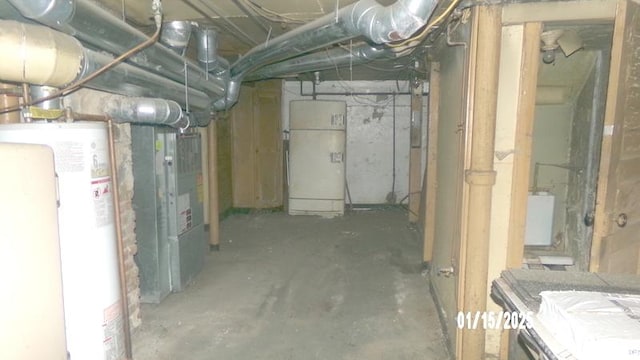 basement with water heater and refrigerator