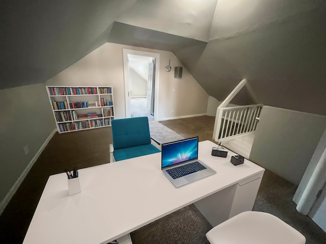 carpeted home office with vaulted ceiling