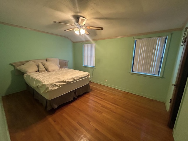 bedroom with ceiling fan, hardwood / wood-style floors, and crown molding