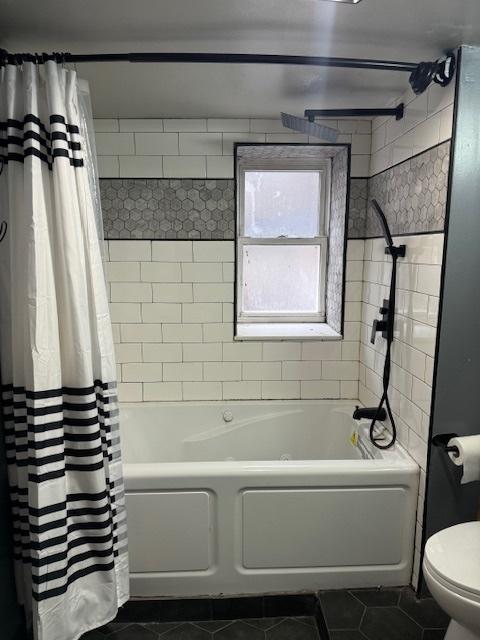 bathroom with tile patterned flooring, toilet, and shower / tub combo with curtain