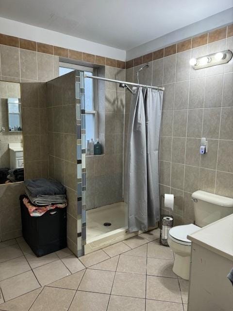 bathroom with tile walls, tile patterned flooring, vanity, and a shower with shower curtain