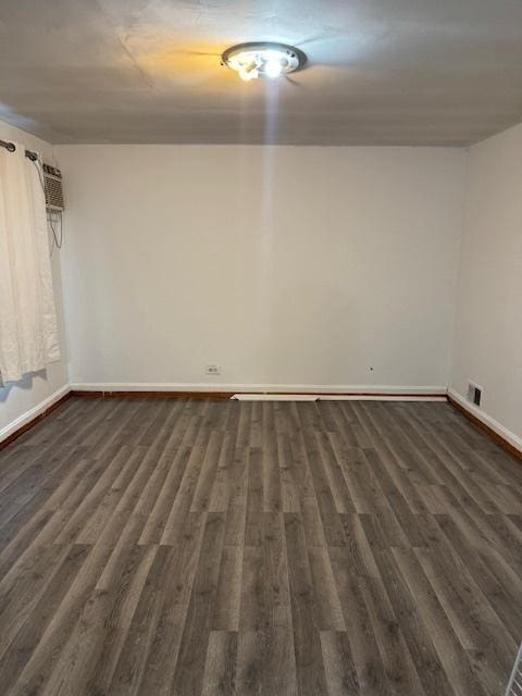 spare room featuring dark wood-type flooring