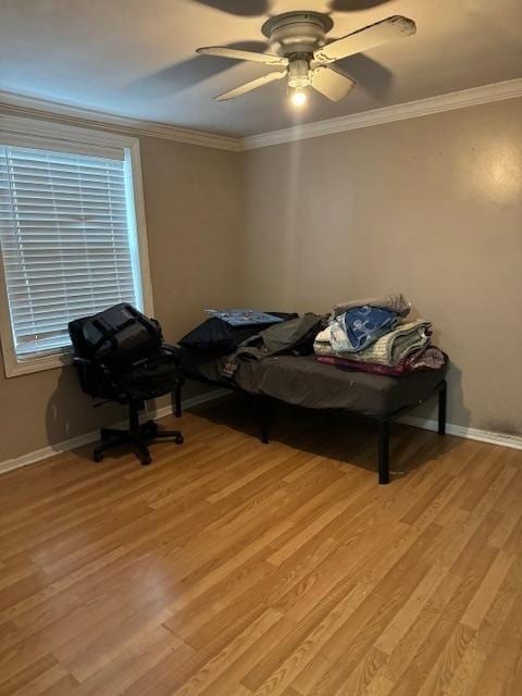 bedroom featuring ceiling fan, light hardwood / wood-style flooring, and crown molding