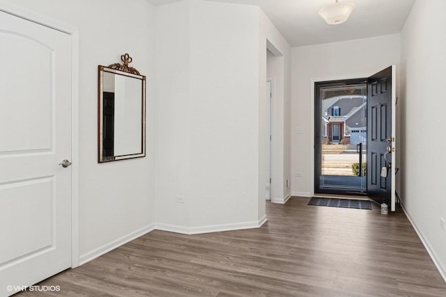 foyer entrance with baseboards and dark wood finished floors