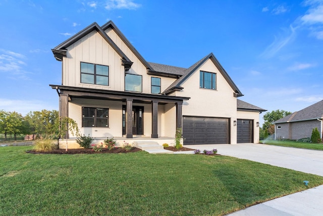 view of front of home with a front lawn, a garage, and a porch