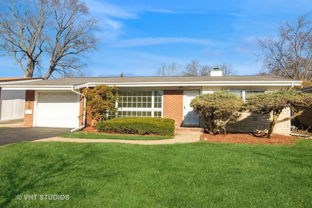 single story home featuring a front yard and a garage