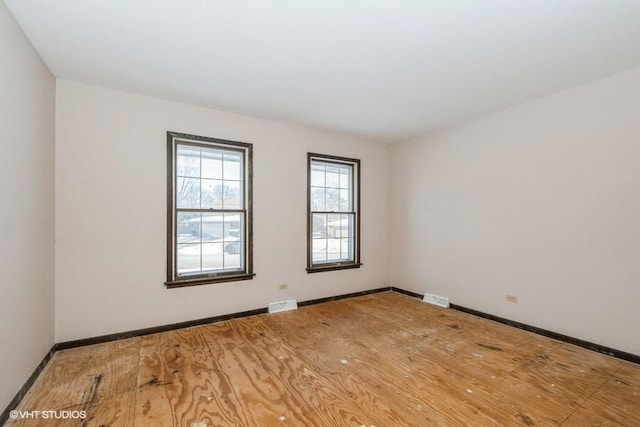 spare room featuring hardwood / wood-style flooring