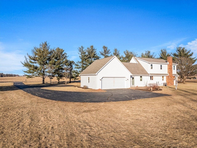 view of property exterior featuring a garage and a yard