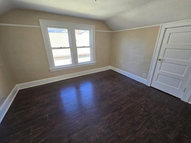 bonus room with dark hardwood / wood-style flooring and vaulted ceiling