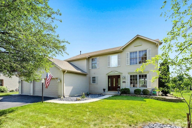 view of front of house with a front yard and a garage