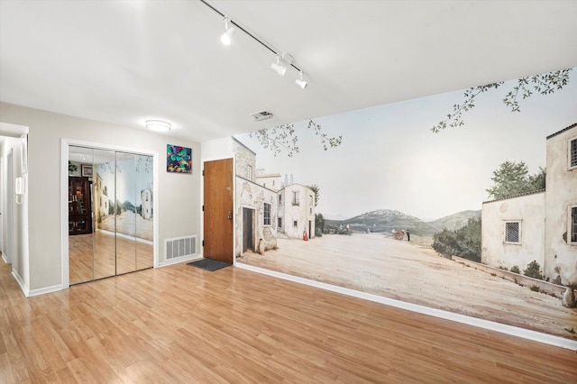 interior space with a mountain view and light hardwood / wood-style floors