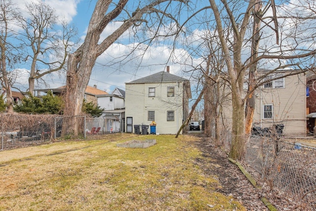 back of property featuring a lawn