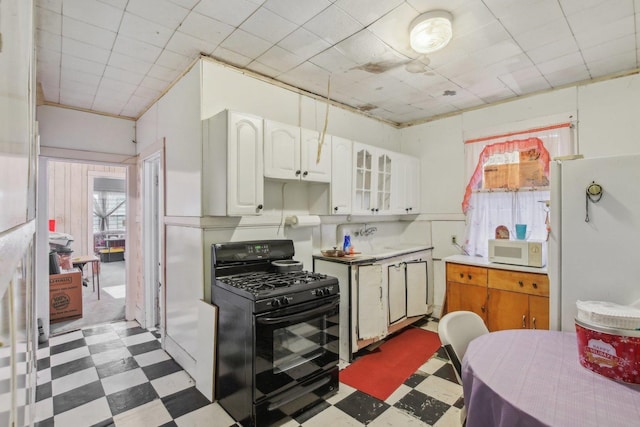 kitchen featuring white cabinetry and white appliances