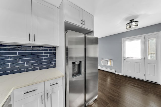 kitchen with decorative backsplash, appliances with stainless steel finishes, light stone countertops, white cabinets, and baseboard heating