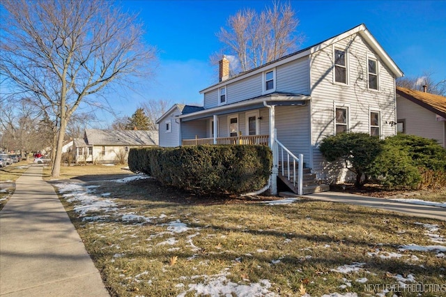 exterior space featuring a porch and a yard