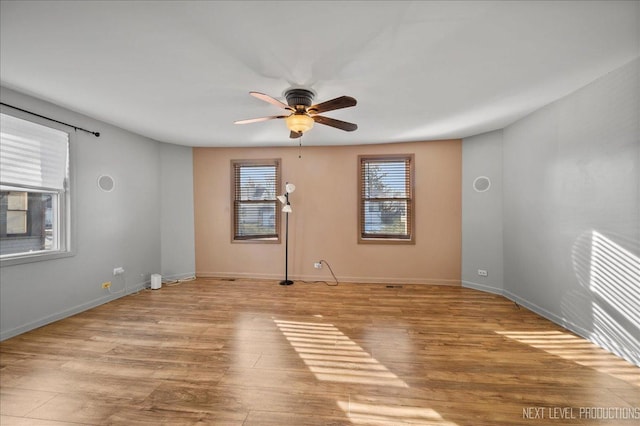 empty room featuring ceiling fan and light wood-type flooring