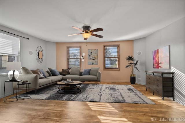 living room featuring ceiling fan and light hardwood / wood-style flooring