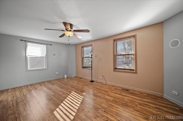 empty room featuring ceiling fan and hardwood / wood-style floors