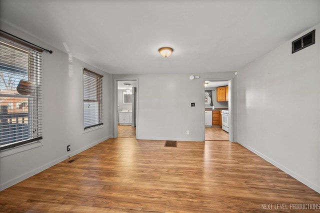 empty room with light hardwood / wood-style flooring