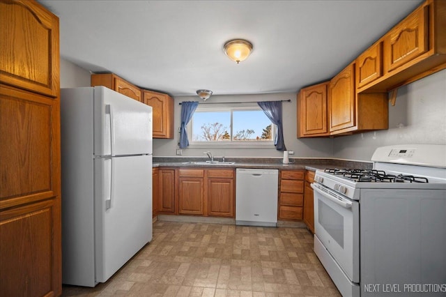 kitchen featuring sink and white appliances