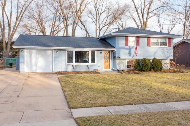 split level home with a garage and a front yard