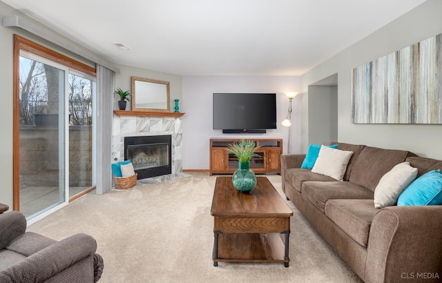 carpeted living room featuring a fireplace