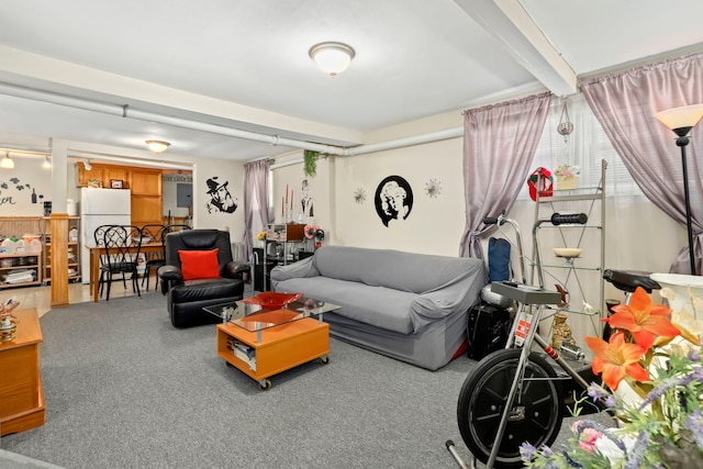 carpeted living room with beam ceiling