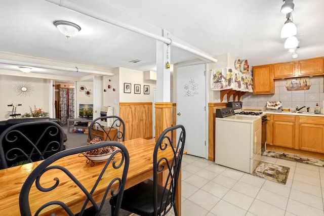 dining room with washer / clothes dryer, sink, and light tile patterned floors