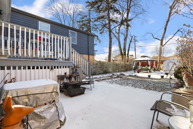 snow covered patio featuring a gazebo