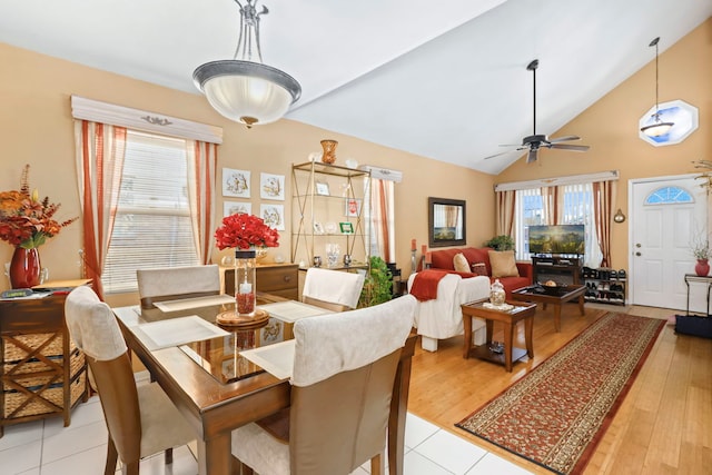 dining space with ceiling fan, lofted ceiling, and light hardwood / wood-style flooring