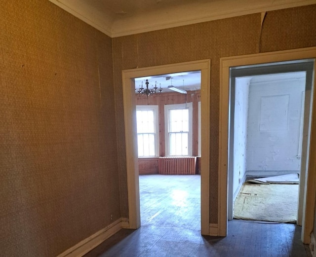 interior space featuring baseboards, ornamental molding, radiator heating unit, and wallpapered walls