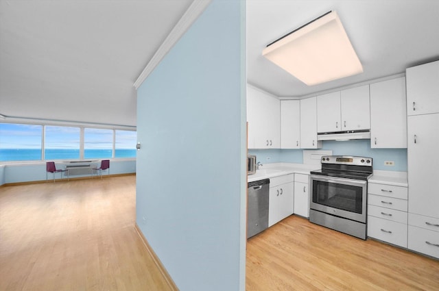 kitchen with light wood-type flooring, stainless steel appliances, a water view, and white cabinets