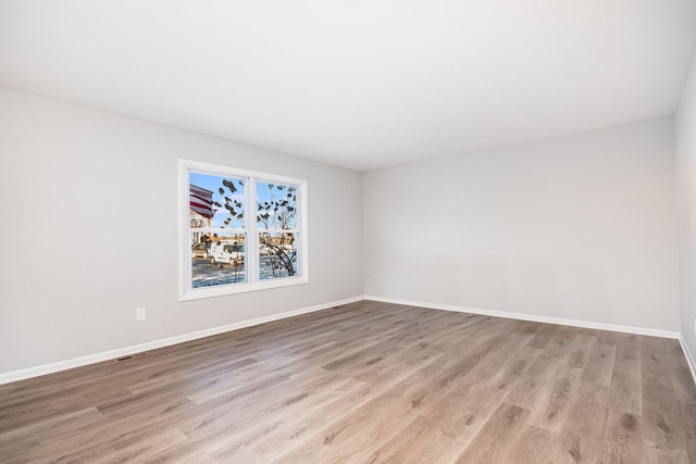 spare room featuring light wood-type flooring