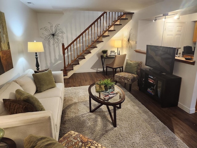 living room with dark hardwood / wood-style flooring