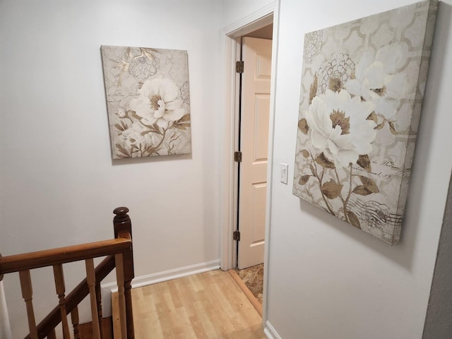 corridor with light hardwood / wood-style flooring