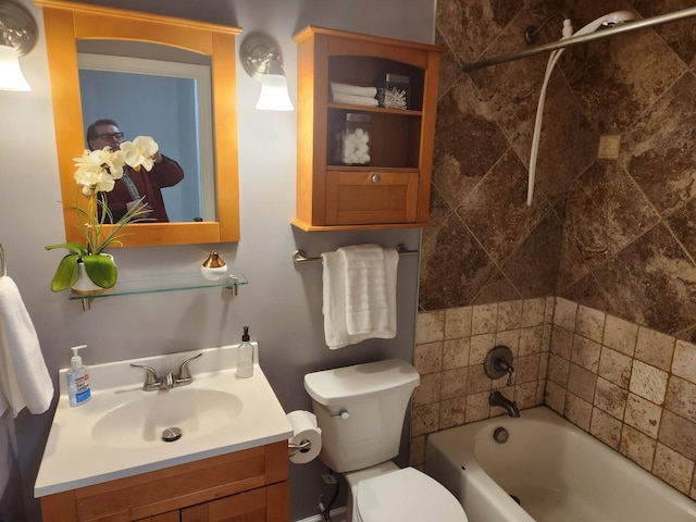 bathroom with toilet, vanity, and a tub to relax in